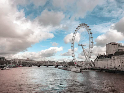 ferris wheel across river on sunny day